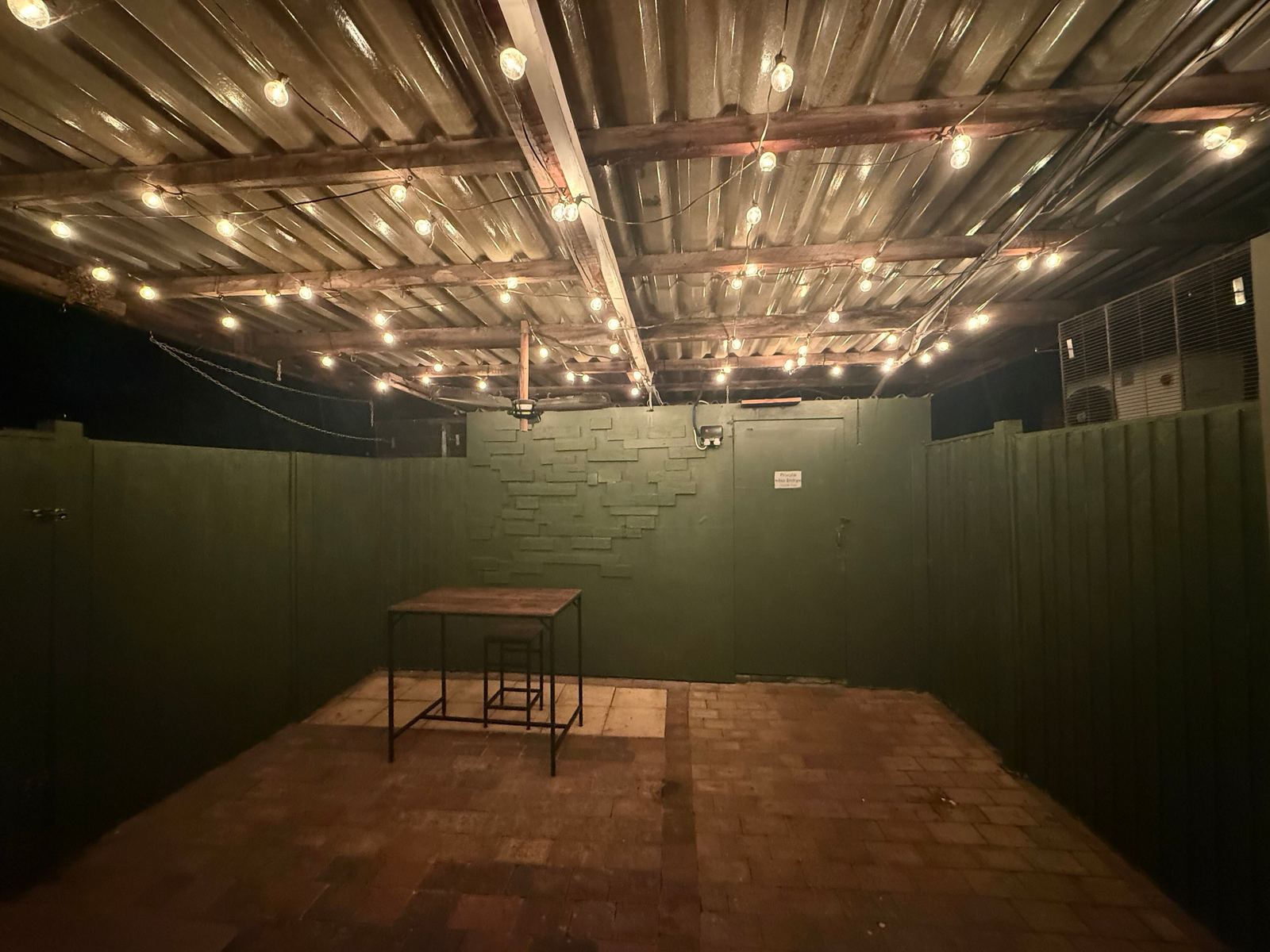 Covered outdoor seating area with festoon lighting